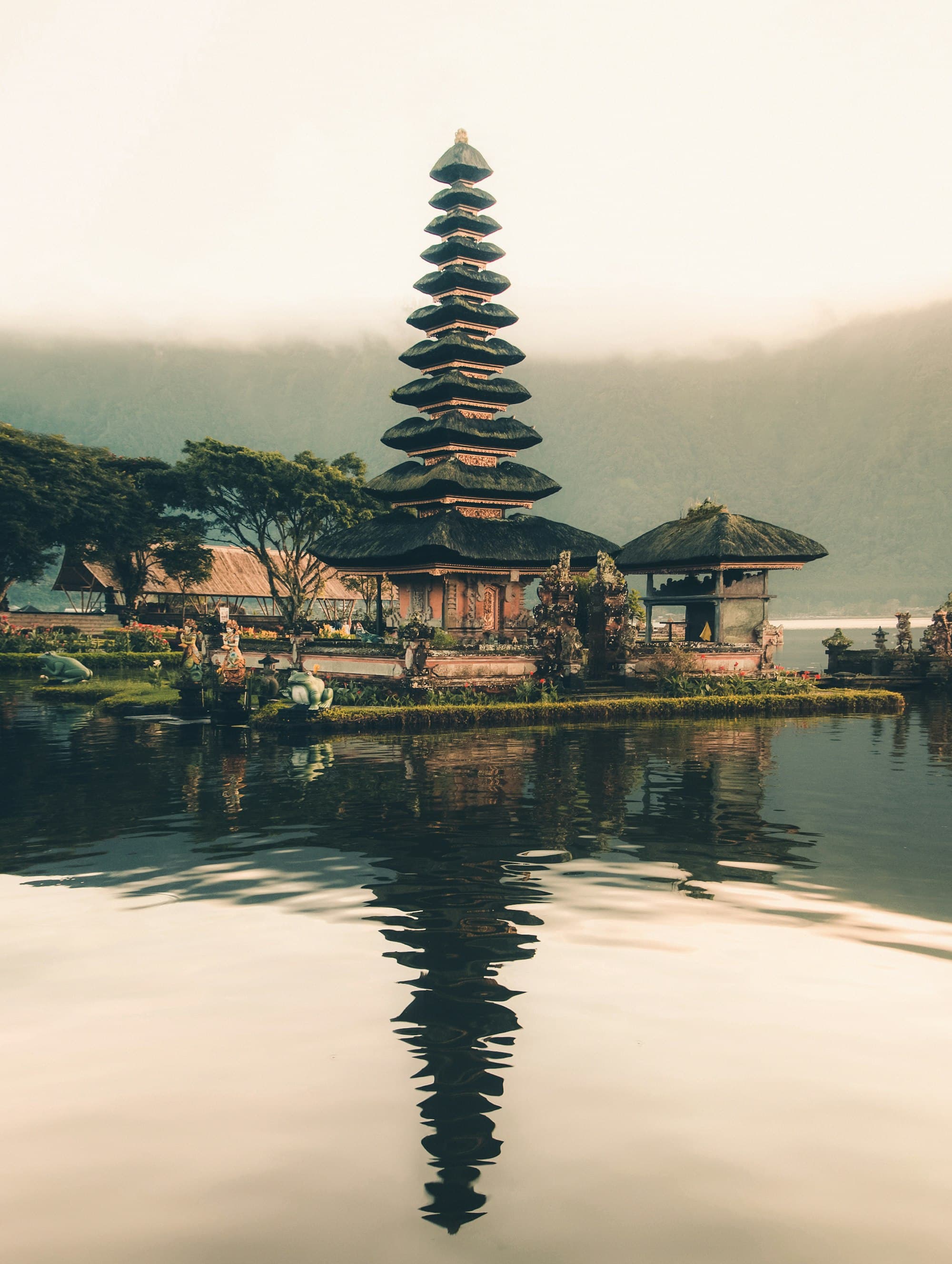 Pura Ulun Danu temple reflected in a still lake at dawn in Bali