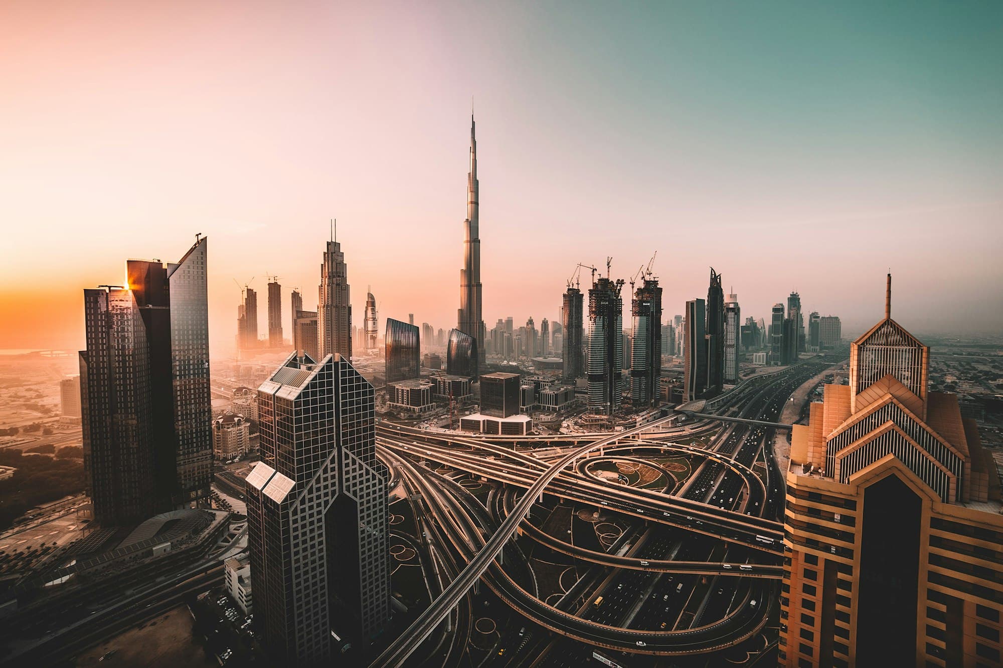 Dubai skyline with the Burj Khalifa rising through sunrise haze